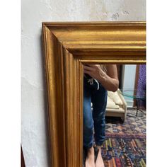 a person sitting in front of a mirror with their feet propped up on the floor