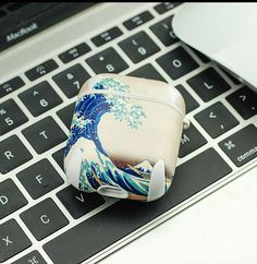 an ipod case sitting on top of a laptop keyboard