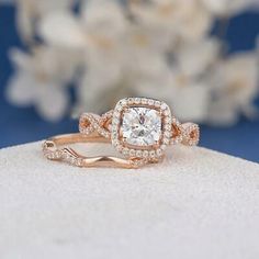 an engagement ring with a diamond center surrounded by white flowers