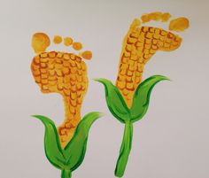 two corn on the cob painted with acrylic paint