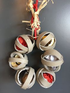 an ornament made out of toilet paper with spoons and other items in it