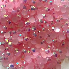 pink sequins are scattered on a white surface