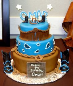 a blue and brown birthday cake sitting on top of a table