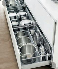 the drawers are open to show pots and pans in their respective drawer spaces,