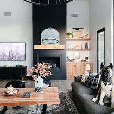 a living room filled with furniture and a fire place in the middle of a room