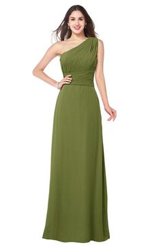 a woman in a green dress posing for the camera with her hands on her hips