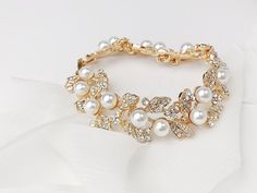 This is a favorite among our brides looking for a classic bracelet to finish their wedding day accessories. Each piece is handmade in the USA. DETAILS *As shown, the bracelet soft off white pearls and clear crystals throughout *Adjustable sizing *Finish is available in Gold or Silver, choose at checkout The goal of your wedding accessories is to compliment your dress and your overall wedding day look, not overpower it. We want our products to make you feel beautiful and special on your wedding d Classic White Bracelets For Wedding, Wedding Pearl Bracelet With Beaded Details, Elegant Gold Crystal Bracelet For Wedding, Wedding Pearl White Beaded Bracelets, Pearl Beaded Bracelets With Pearl Charm For Wedding, Cream Beaded Bracelets For Wedding, Classic White Wedding Bracelets, Classic White Crystal Bracelet For Wedding, Classic Elegant Bracelets For Wedding