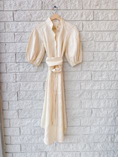 Indulge in luxury with the Cream Kaftan Midi. Crafted from soft linen, this kaftan boasts a stand collar, elasticated blouson sleeves, and a removable tie belt. The midi length adds to the sophisticated appeal, while the removable tie belt allows for versatility in styling. Elevate your wardrobe with this timeless and elegant piece. A Stand, The Cream, Tie Belt, Stand Collar, Midi Length, Wardrobe, Cream, Collar, Dresses