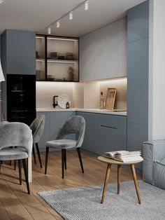 a living room filled with furniture next to a kitchen