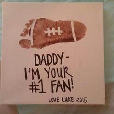 a handprinted card with a football on it says daddy i'm your 1 fan