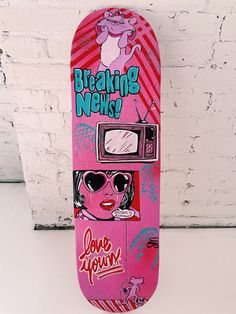 a pink skateboard with the words breaking news on it and an image of a woman wearing sunglasses