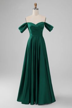 a green dress on a mannequin dummy with the back turned to show it's off shoulder