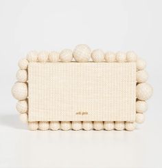 This Cult Gaia Eos Clutch is the perfect statement accessory for any occasion! Featuring a structured design with bead trim, this bag is made of woven raffia and has a snap closure at the top. The textile lining and weight of 25oz make it both practical and stylish. Available in Sand color and one size, this clutch is priced at $458.00. Shopbop affiliate. #CultGaia #StatementAccessory" Structured Design, Summer Dates, Woven Raffia, Strapless Tops, Cult Gaia, Romantic Dinners, Beaded Trim, Sand Color