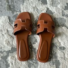 Tan, Faux Leather With White Stitching. Slip On Sandal. Never Worn, Fit Is Tts. Chic Brown Slide Sandals, Casual Tan Synthetic Sandals, Casual Tan Open Toe Sandals, Casual Open Toe Tan Sandals, Casual Tan Flat Sandals, Casual Tan Flat Heel Sandals, Summer Brown Open Toe Mules, Brown Leather Summer Mules, Brown Open Toe Summer Mules