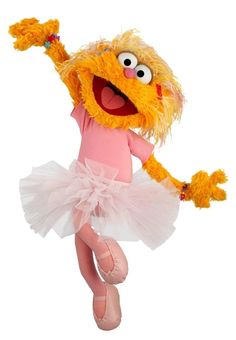 the sesame character is wearing a tutu and holding her arms up in the air