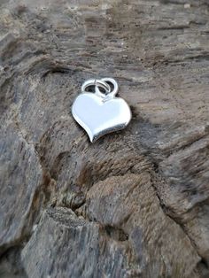 Garnet Sterling Silver Heart Pendant Cute solid sterling silver flat heart pendant with a since round pink Garnet (possibly tourmaline) cabochon bezel set. Perfect for your self or as a gift. Small enough to be a pendant or worn on a charm bracelet. Marked Sterling Measures 18mm by 11.9mm. Stone measures about 2mm Vintage good condition Stone origin, treatments unknown. Tested on Presidium Gem Tester II. Sterling Silver Heart Charm Round Pendant, Sterling Silver Heart Charm Pendant, Sterling Silver Heart Charms For Valentine's Day, Heart-shaped Sterling Silver Charms For Valentine's Day, Silver Heart Pendant Charms For Mother's Day, Heart Pendant Charms For Gifts, Mother's Day Silver Heart Pendant Charm, Valentine's Day Heart Shaped Sterling Silver Charms, Valentine's Day Heart-shaped Sterling Silver Charms