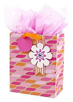 a pink and orange gift bag with tissue paper on it's handle, decorated with an image of a flower