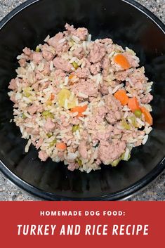 a black bowl filled with meat and rice on top of a counter next to a red sign