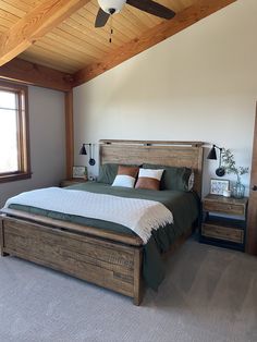 a bedroom with a bed, nightstands and a ceiling fan in the middle of it