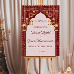 a welcome sign is displayed in front of a white backdrop with red and gold accents