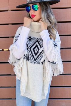 Layer up effortlessly in this fringe poncho sweater. With a cozy turtleneck and a trendy aztec design and fringe detailing. This is an easy piece to wear and pairs nicely with jeans, leggings and boots! 100% Polyester Imported Length 28" Width 32" One Size Fits Most Aztec Poncho, Fringe Poncho, Fringed Poncho, Aztec Design, Aztec Designs, Jeans Leggings, Black Fringe, Poncho Sweater, Turtle Neck