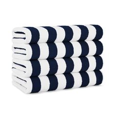 four towels stacked on top of each other in blue and white stripes, one folded up