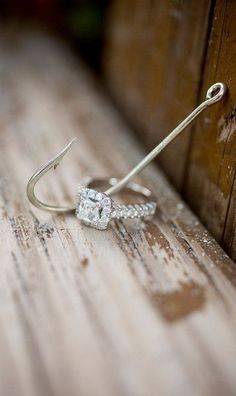 a pair of earrings sitting on top of a wooden table