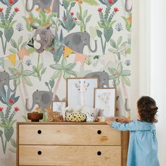 Discover the whimsical charm of our Elephant Eden wallpaper, a delightful choice that transforms any child’s room into a magical jungle. Featuring soft-hued elephants amidst a lush array of greenery and florals, this design invites the serenity of nature right into your home. The gentle elephants, with their friendly expressions, pair beautifully with vibrant tropical leaves and subtle floral accents, creating a soothing yet playful environment perfect for nurturing imagination and dreams. At Te Eloise Nursery, Eden Wallpaper, Safari Wallpaper, Magical Jungle, Wallpaper Project, Classic Wallpaper, Wallpaper Rolls, Wallpaper Size, Nursery Wallpaper