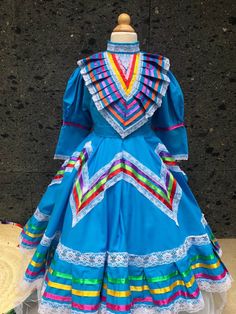 1 Mexican ONE PIECE JALISCO DRESS COLOR BLUE  Ask for different sizes and colors SIZE 10 check measurements - kids WAIST TO FLOOR 30 inches Top to waist 12.5 inches Waist 15 inches sleeve 15.5 inches armpit to armpit 18 inches from shoulder to shoulder 16 inches two ties of 26 inches each Note: All color embroidery is slightly different, every dress is handmade, so they are different from one another, as a result you will own a unique piece. You will receive the color you selected, only embroide Folklorico Dresses Pattern, Jalisco Dress Purple, Mexican Barbie, Jalisco Dress, Folklorico Dresses, Folkloric Dress, Clothing Construction, Womans Dress, Mexican Boho