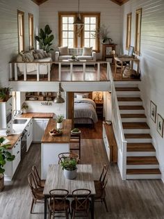 an open floor plan with stairs leading up to the loft