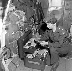 a woman in uniform sitting on the floor next to luggage