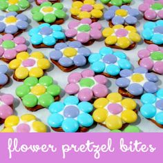 there are many different colored flowers on the table with words above it that read flower, pretzel bites