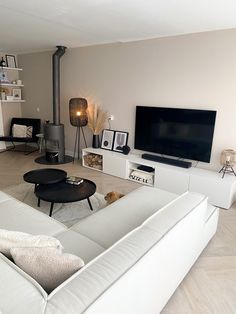 a living room filled with furniture and a flat screen tv on top of a wall