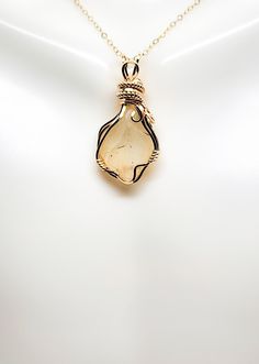 📌Handmade Item📌 ✨Libyan Desert Glass Pendant in 14k Gold Filled Wire is created using 14k gold filled wire with a beautiful raw Libyan Desert Glass stone. The Desert glass has a beautiful shade of pale yellow with beautiful transparency and orbs and is approximately 8.5 ct.  ✨This pendant is 1.39 inches long and 0.67 inches wide. This comes with either a free 16, 18 or 20-inch 14k gold filled starter chain or a waxed leather cord as a gift for your purchase. ✨Aesthetic Jewelry will make a timeless gift and the perfect romantic gift. All pendants are shipped in a pretty velvet cushioned gift box and processed to be shipped in 1 business day. The pendant pictured is one of a kind and will be the pendant you will receive. ✨ Libyan Desert Glass, also known as Libyan Gold Tektite or Great San Yellow Gold Wire Wrapped Jewelry For Healing, Artisan Gold Jewelry With Birthstone, Handmade Gold Citrine Jewelry, Yellow Wire Wrapped Necklace For Gift, Yellow Wire Wrapped Necklace As Gift, Citrine Crystal Necklace Gift, Artisan Amber Jewelry With Natural Inclusions, Gold Untreated Jewelry As A Gift, Unique Gold Citrine Jewelry