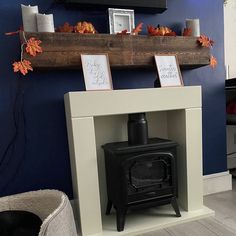 a wood burning stove sitting inside of a living room next to a tv mounted on a wall