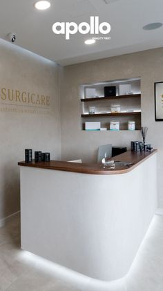 the front desk of a salon with shelves on either side and an open shelf above it