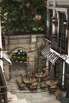 an aerial view of a patio with umbrellas and tables in the middle of it