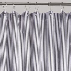 a striped curtain hanging on a metal rod