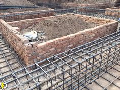 the foundation of a building being constructed with bricks and steel bars on top of it