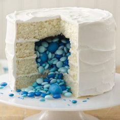 an image of a cake with blue and white frosting on the top, next to a book