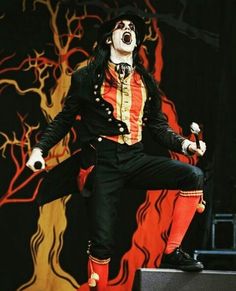 a man dressed as a clown on stage