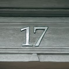 the number 17 is engraved on an old building