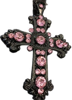 a cross with pink stones on it