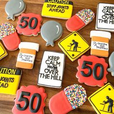 decorated cookies are arranged on a table with caution signs and street signs in the background