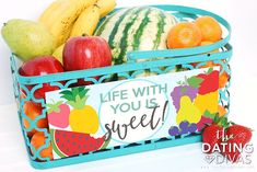 a blue basket filled with lots of different types of fruits and veggies next to a sign that says life with you is sweet