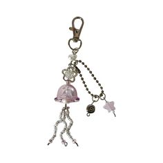 a keychain with a bell and star charms attached to it's side