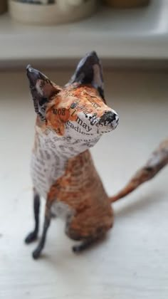 a small toy fox sitting on top of a table