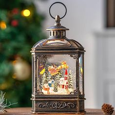 a christmas scene in a glass lantern on a table