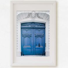 a blue door is in front of a white wall