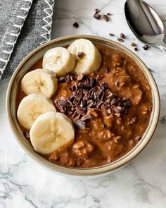 a bowl of oatmeal topped with bananas and chocolate